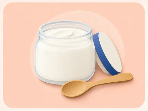 A glass yogurt pot with a spoon